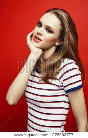 Young Pretty Teenage Girl On Bright Red Background, Happy Smilin