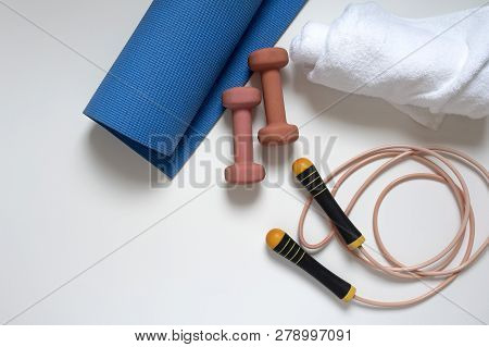 Jump Rope, Yoga Mat, Dumbbells, White Bath Towel, Close-up On A White Background