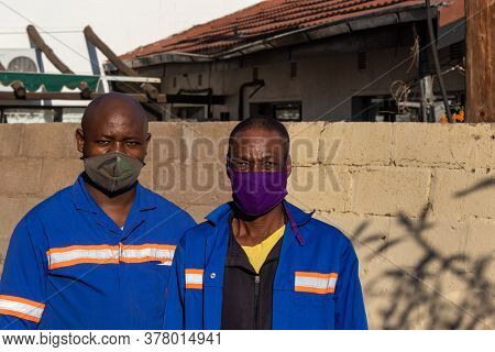 portrait of two African workers onsite