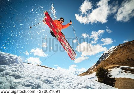 Jump With A Trick In The Ozdou Athlete Skier With A Kicker On A Sunny Day Of Spring Or Winter Agains