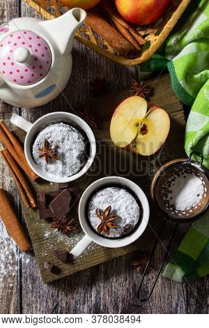 Quick Autumn Dessert. Autumn Apple Pie Mugcake With Red Apples And Spices On A Rustic Background. To