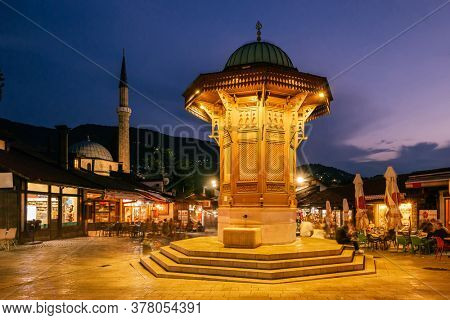 Long exposure photo of Bascarsija square with Sebilj wooden fountain in Old Town Sarajevo at twilight, Bosnia and Herzegovina