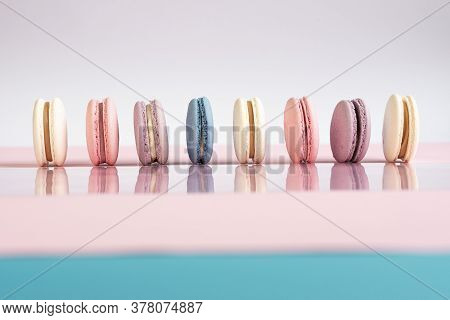 Multicolored Macarons On A White, Pink Background.
