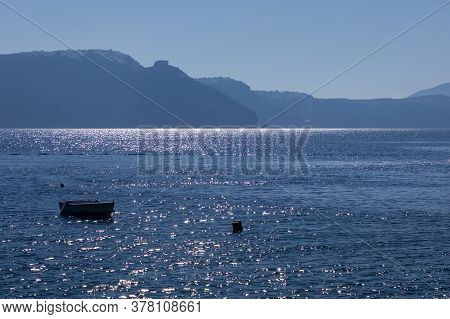 The Bright Blue Ocean Near Amoudi Bay On Santorini Island In Greece