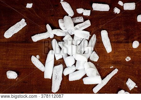 Top View Of White Cool Dry Ice (frozen Carbon Dioxide) With Smoke Effect On The Dark Brown Wooden Ba