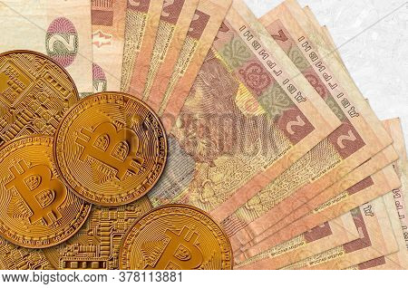2 Ukrainian Hryvnias Bills And Golden Bitcoins. Cryptocurrency Investment Concept. Crypto Mining Or 