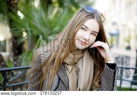 Young Long Hair Woman Model Of Clothes In The Garden In Spring Posing