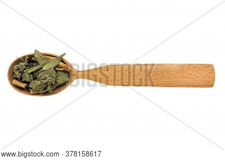 Dried Galega Officinalis In A Wooden Spoon On A White Background. Phytotherapy And Disease Preventio