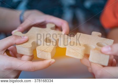 Businesswoman Hand Of Teamwork Holding Jigsaw Puzzle Connecting, Business Team Work Of Solutions In 