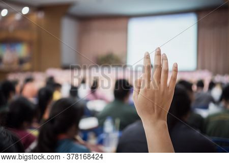 Audience Raising Hand While Speaker On Stage At Conference To Answer Question While Speaker Speech A