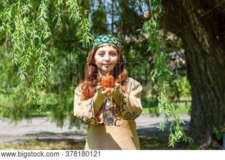 Armenian Young Woman In Traditional Clothes In The Forest With Pomegranate