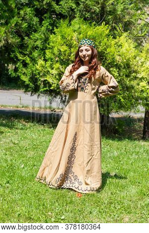 Armenian Young Woman In Traditional Clothes In The Forest