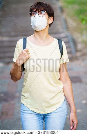 Beautiful Middle-aged Woman Walking Down The Street