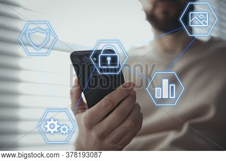 Information Security. Young Man Using Smartphone Indoors, Closeup