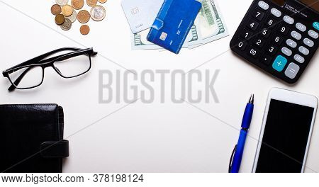 Wallet, Credit Card, Money, Glasses, Blue Pen, Telephone And Calculator Lie On A Light Background. B