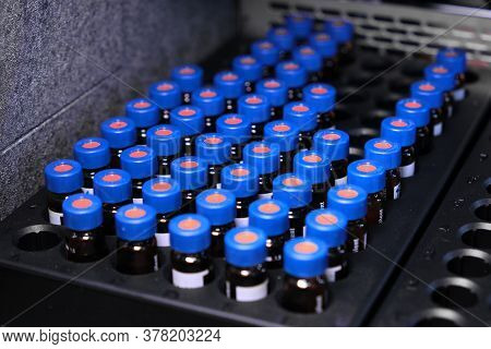 Glass Vials With Blue Caps Are In The Rack Of Hplc System With Autosampler. Separation Of Compounds 