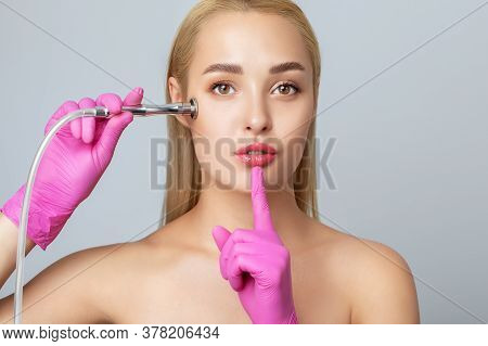 Beautiful Young Blonde Woman With Clean Fresh Skin Naked Shoulders Holds A Nozzle For Microdermabras