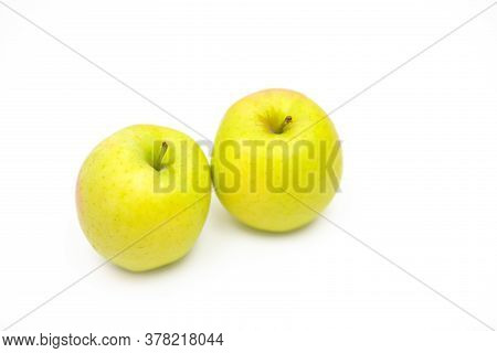 Two Fresh Yellow Apples On A White Background