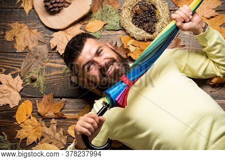 Cheerful Man Rejoices In Autumn Sales. Autumn Discounts On Clothes. Man With Rainbow Color Umbrella.