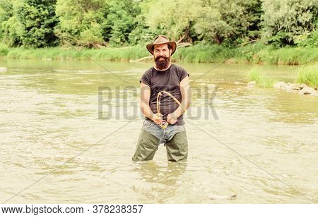 Pro Fishing. Bearded Fisher In Water. Hobby And Sport Activity. Pothunter. Fisherman With Fishing Ro
