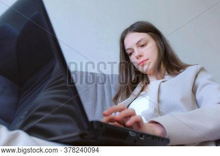 Freelancer Woman Working Typing On Laptop At Home Sitting On Couch, Freelance Distant Work On Quaran