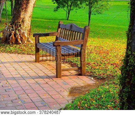 A Wooden Chair Outside In The Park