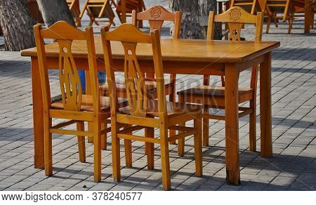 A Wooden Chair Outside In The Park