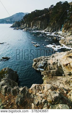 Winter Sea Landscape, Rocks On The Sea With Ice, Mountain Background, Telyakovsky Bay Far East, Russ