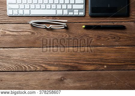 Top View Office Workspace Composition. Flat Lay Vintage Wooden Desk With Pc Keyboard And Graphic Dra