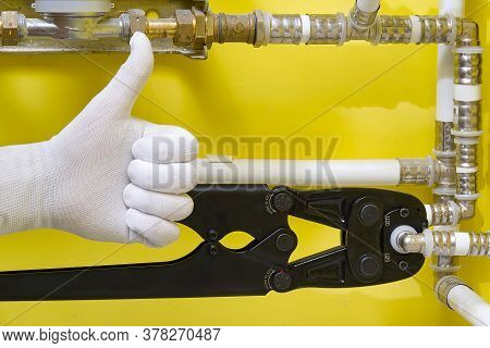 Worker Connecting Alupex Pipes With A Tap. Hand Press For Water Pipes Pex - Al - Pe-x. Plumbing Indu