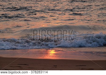 Wave rolling over the sands on Candolim Beach, North Goa, India