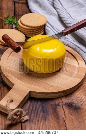 Dutch Baby Gouda Cheese In Yellow Wax Close Up