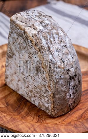 Pieces Of Cheese Tomme De Montagne Or Tomme De Savoie Made From Cow Milk In French Alps.