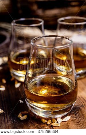 Speyside Scotch Whisky Tasting On Old Dark Wooden Vintage Table With Barley Grains Close Up
