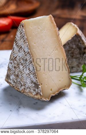 Pieces Of Cheese Tomme De Montagne Or Tomme De Savoie Made From Cow Milk In French Alps.