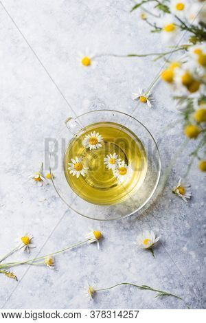 Chamomile Flowers And Chamomile Tea In Glass Teacup, Top View, Prevention Of Seasona Flu Colds