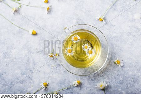 Chamomile Flowers And Chamomile Tea In Glass Teacup, Top View, Prevention Of Seasona Flu Colds
