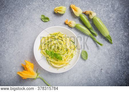 Zucchini Vegetable Noodles - Green Zoodles Or Courgette Spaghetti On Plate Over Gray Background. Cle
