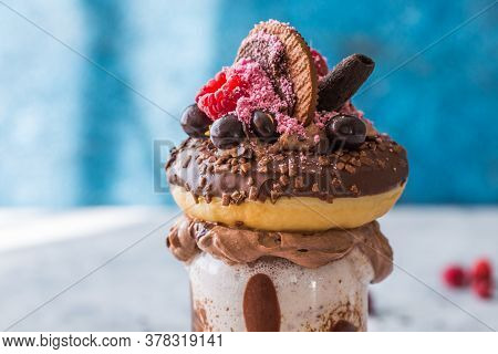 Feakshake. Chocolate Indulgent Frosting Exreme Milkshake With Donut  And Sweets. Crazy Freakshake Fo