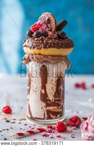 Feakshake. Chocolate Indulgent Frosting Exreme Milkshake With Donut  And Sweets. Crazy Freakshake Fo