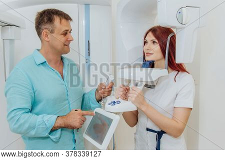 A Girl Patient Makes A Panoramic X-ray Of The Oral Cavity On An Orthopantomographic Apparatus, And T