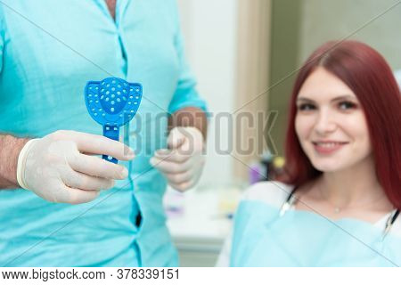 The Orthodontist Shows The Patient An Impression Tray In Which The Silicone Impression Material Will