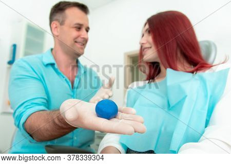 The Orthodontist Crumples The Silicone Material For The Impression Tray That Will Be Placed In The P
