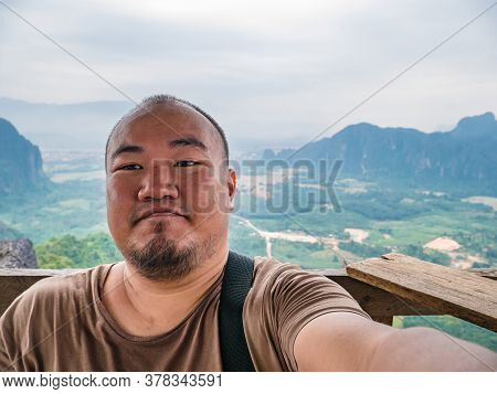 Portrail Photo Of Fat Tourist With Beautiful View On The Peak Of Pha Ngeun In Vangvieng City Laos.va
