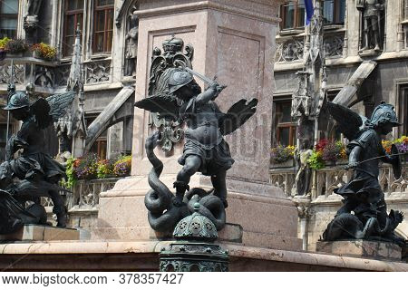Close-up Ancient Statue Of Putto Killing Devil At The Marian Column\'s Pedestal Marienplatz, Munich,