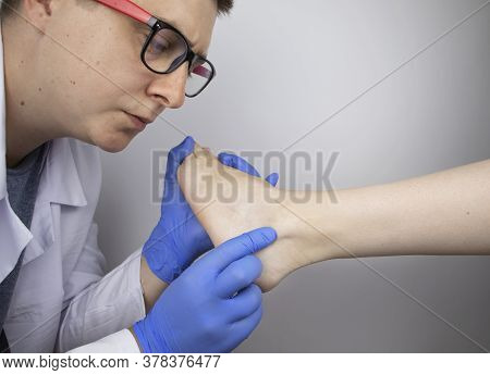 The Podiatrist Examines The Heel And Its Ridges In A Patient Who Complains Of Acute Pain. Suspected