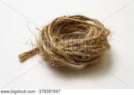 Jute Twine Isolated On White Background. Hank Of Twine Close-up. Jute Rope For Packing And Decoratio
