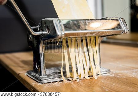 Chef Rolling Dough With A Pasta Machine. Pasta Maker Machine.