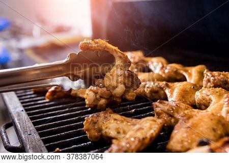 Fried Chiken Wings At Grill Barbecue. Restaurant.