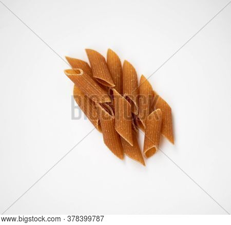 Raw Wholemeal Pasta On A White Background